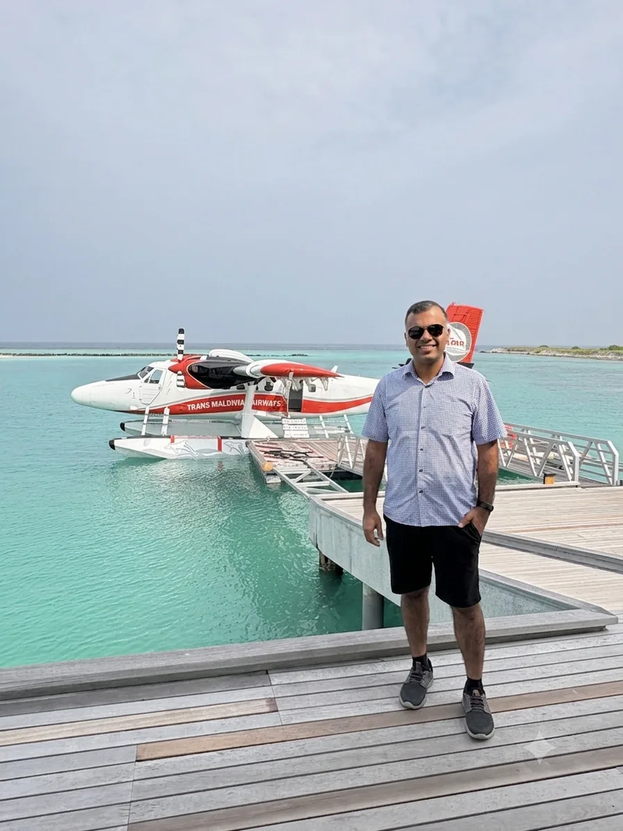 Mayank Arora, founder of Away with Miles, standing beside a seaplane.
